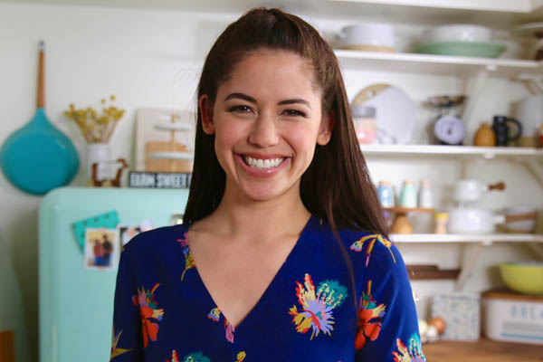 Molly Yeh in her kitchen filming for Girl Meets Farm