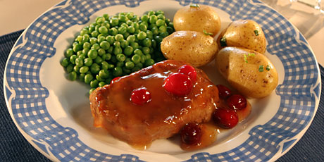 Pork Chops and Simmered Fresh Cranberries with Potatoes and Peas