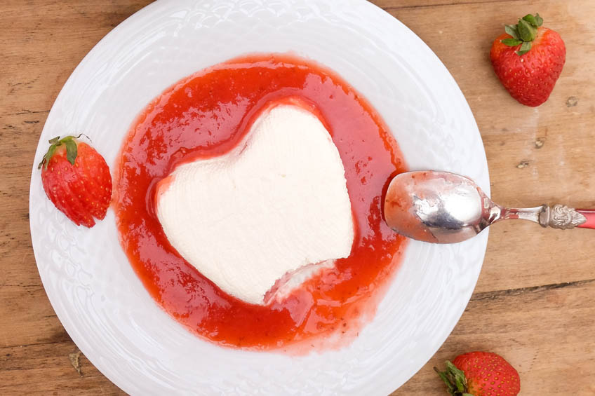 Strawberry Coeur à la Crème on a white plate with a bite taken out