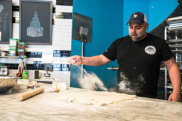 Duff flouring a counter and rolling out dough