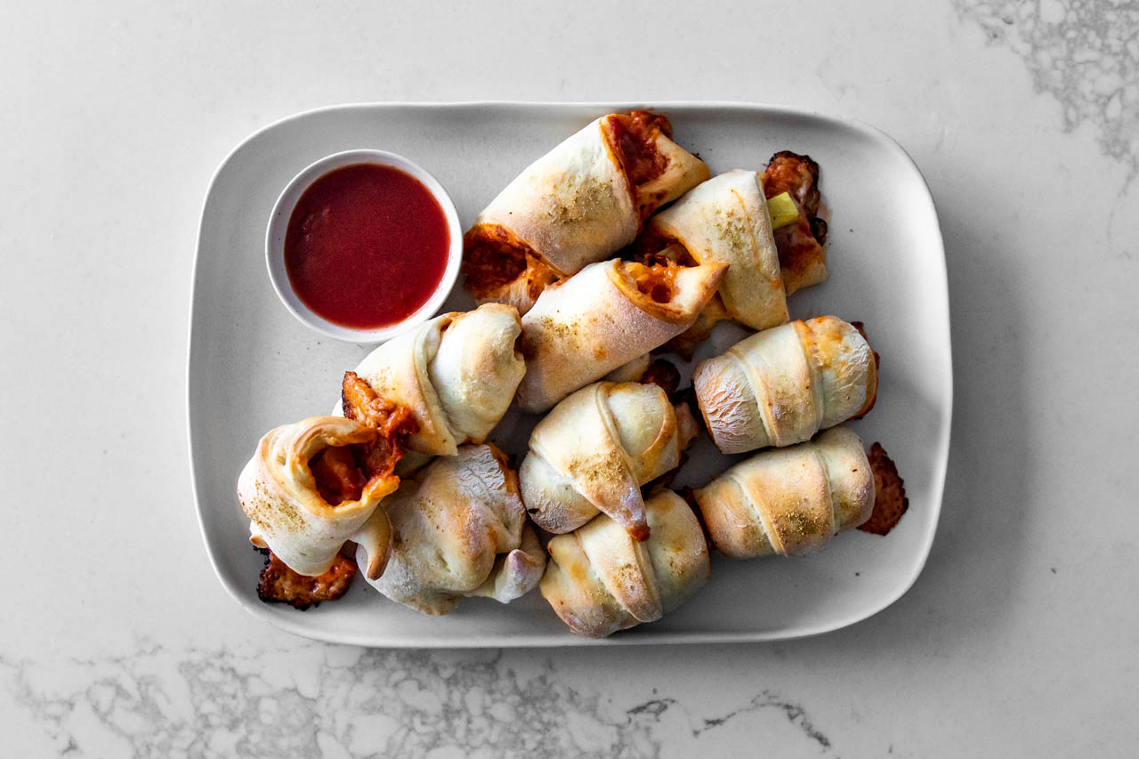 Hawaiian pigs in a blanket on a white plate.