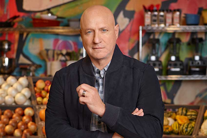 Tom Colicchio facing the camera on the set of Last Chance Kitchen