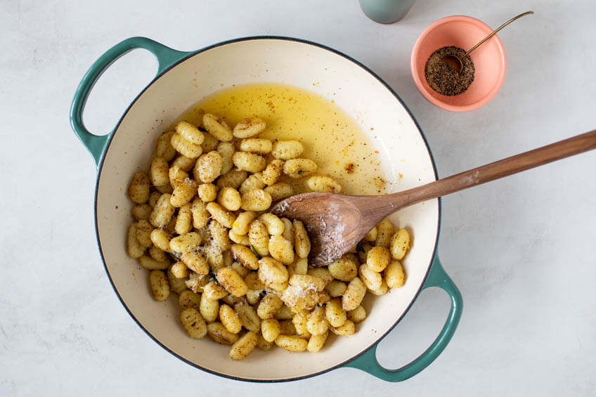 A pot of gnocchi with brown butter sauce