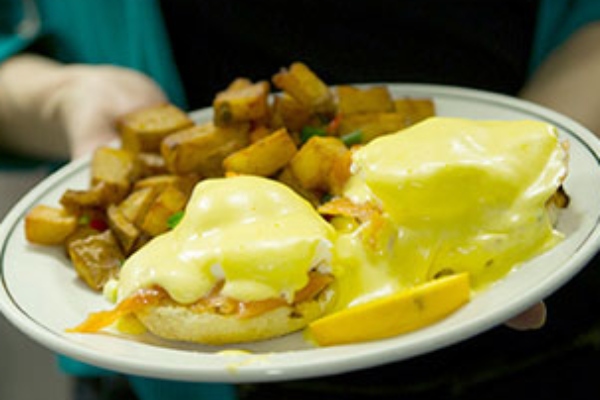 Smoked salmon Benedict smothered in yellow Hollandaise sauce