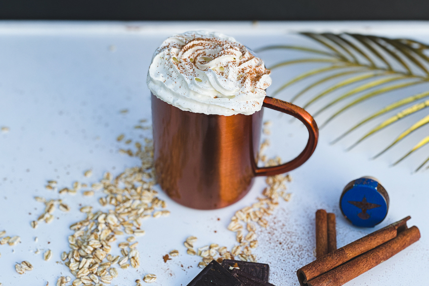 A copper mule mug with tequila-spiked hot chocolate and a whipped cream topping