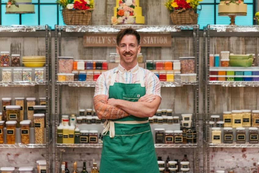 A picture of Tom Smallwood in a green apron