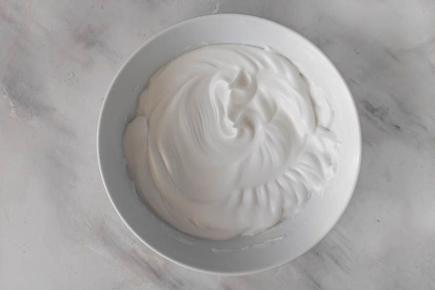 Whipped egg whites in a bowl