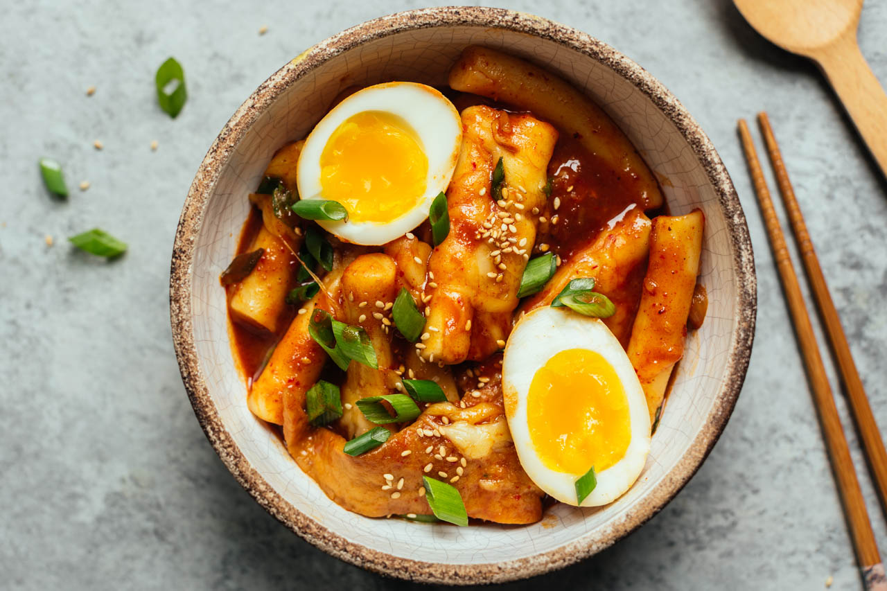 A bowl of cheese ttetokbokki with boiled eggs