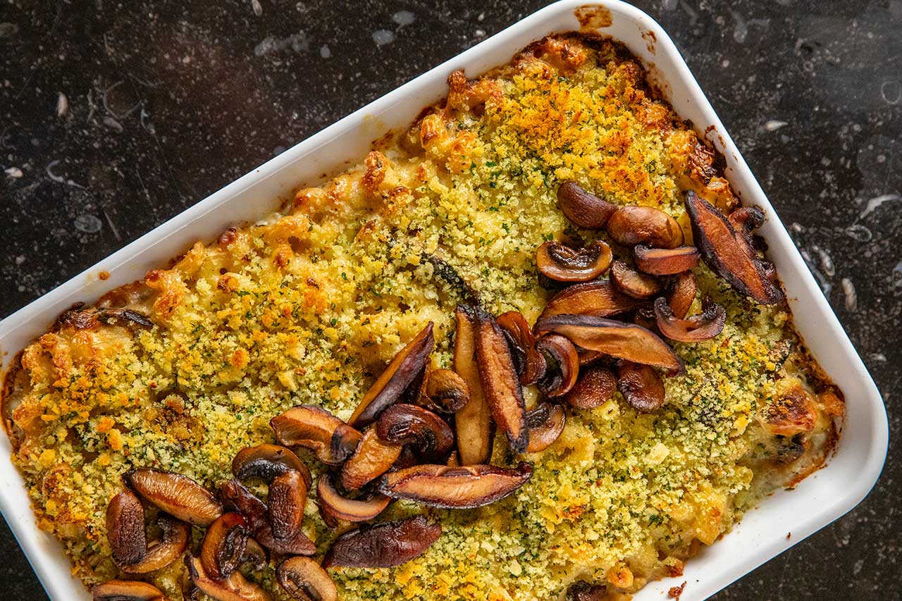 pan of baked truffled mac and cheese decorated with mushrooms