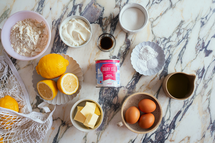 Flat lay of ingredients needed to make a lemon sheet cake with sour cream frosting