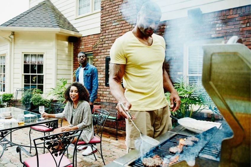 family grilling outdoors with BBQ