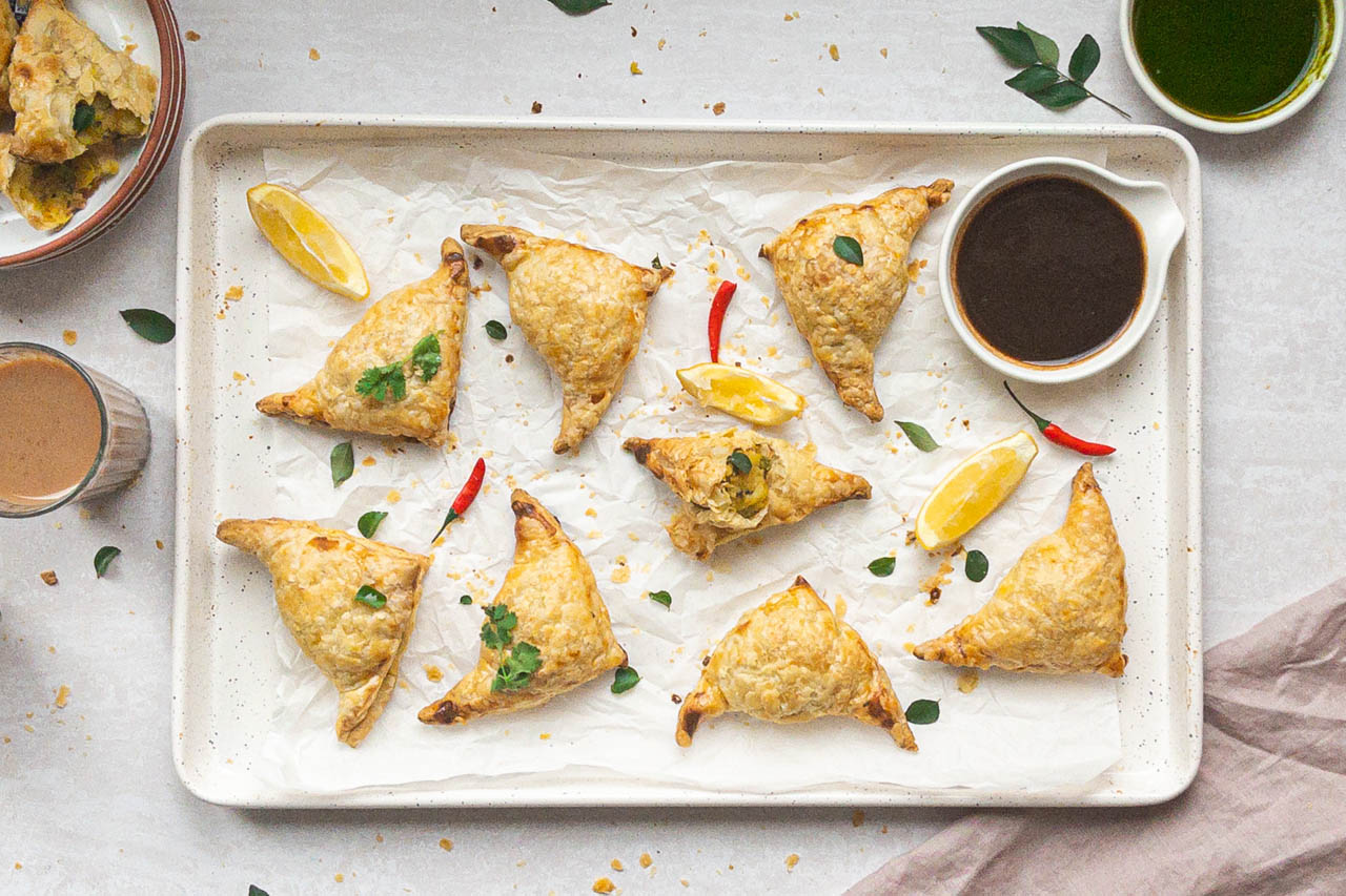 puff pastry samosas on a serving platter