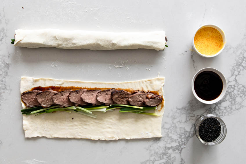 Deconstructed Peking duck roll on a marble countertop