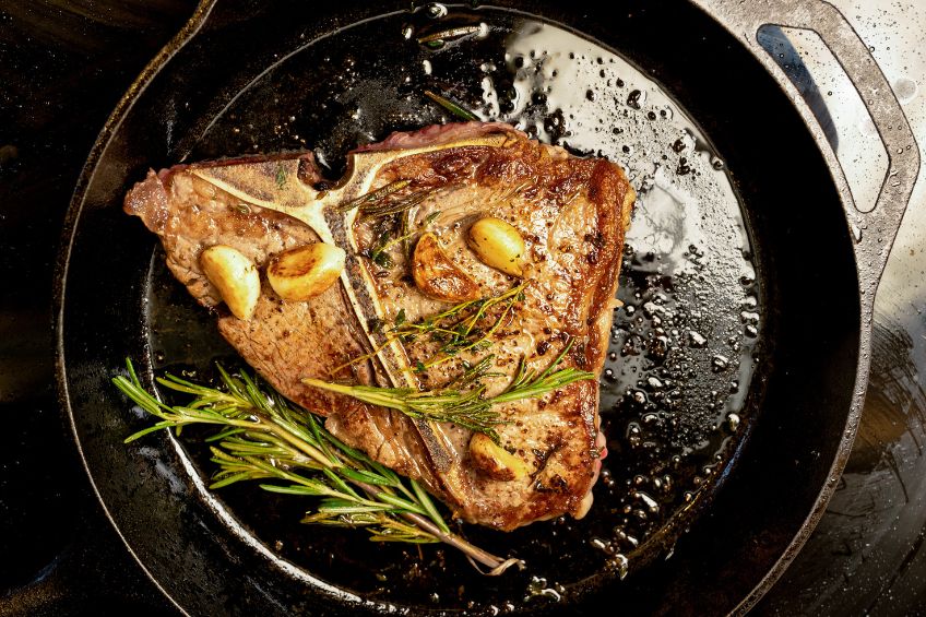 steak searing on a pan