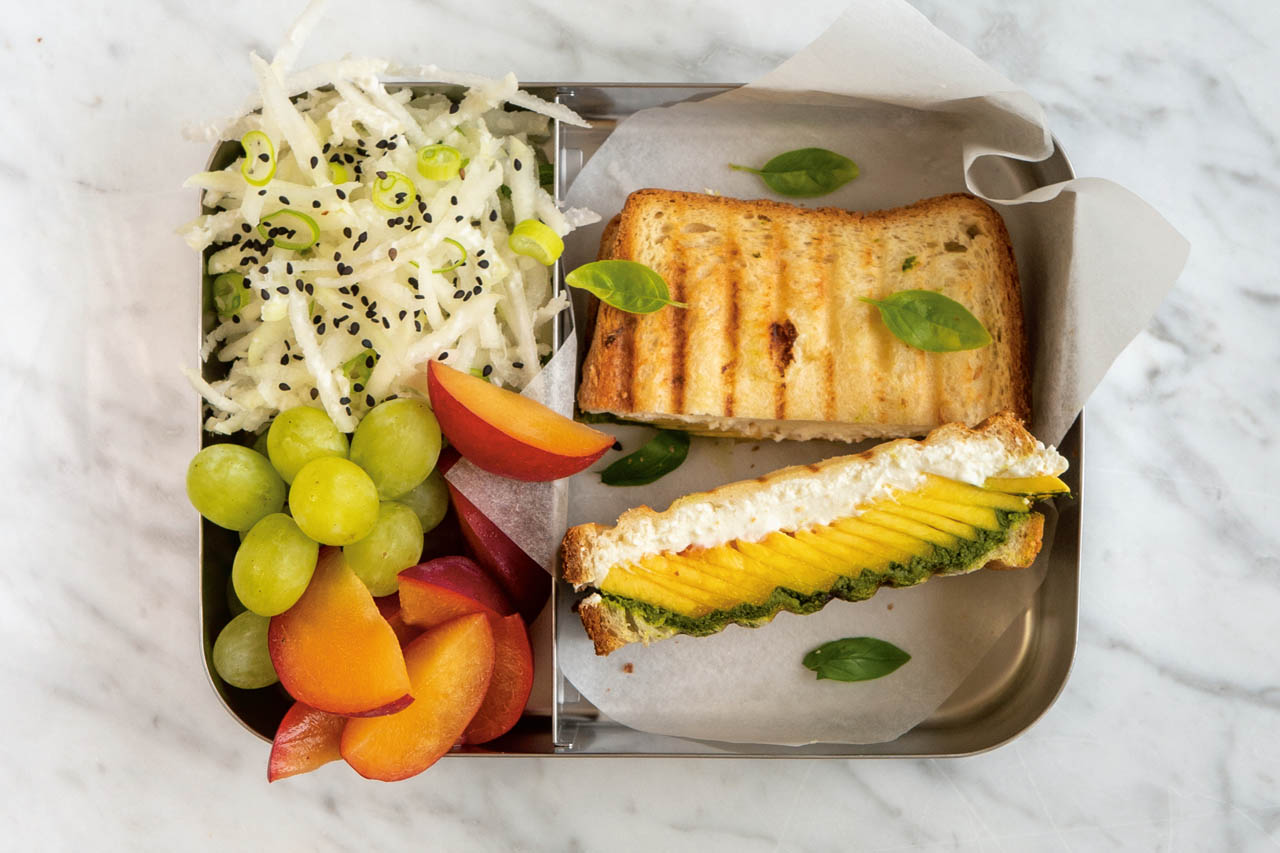 Goat cheese, basil and peach panini in a lunchbox