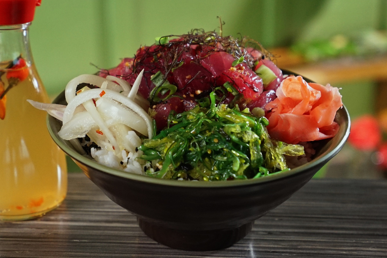 Close-up food beauty of an ahi tuna poke bowl with ginger, seaweed salad and fresh tuna