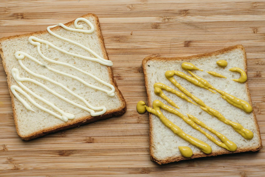 Bread topped with mustard and mayonnaise