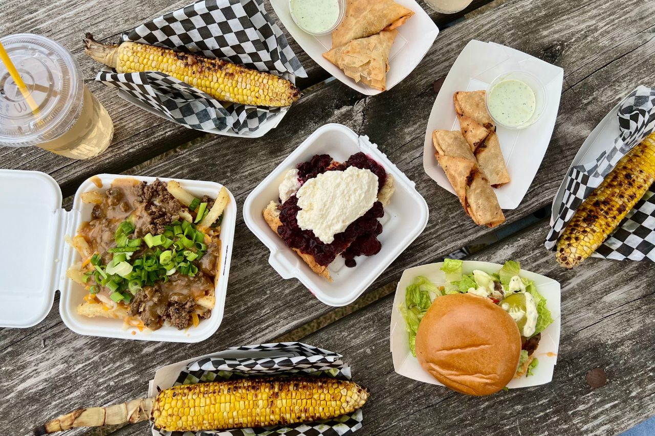 Indigenous food market spread of food including corn, burgers, fries and bannock