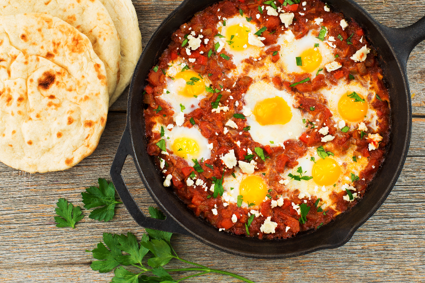 Tomato and egg shakshuka with a side of naan breads