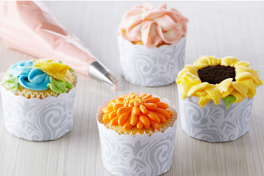 floral cupcakes being frosted