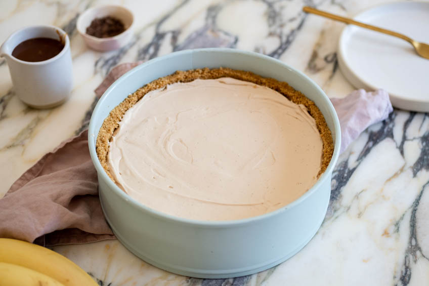 No-bake bannoffee cheesecake base layer in a spring form pan