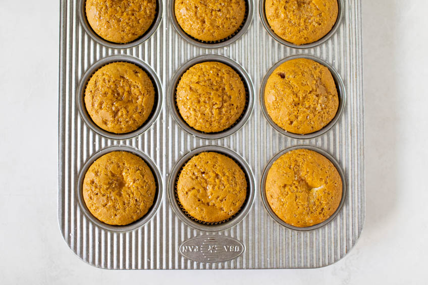 Pumpkin cream cheese muffins in a muffin tin
