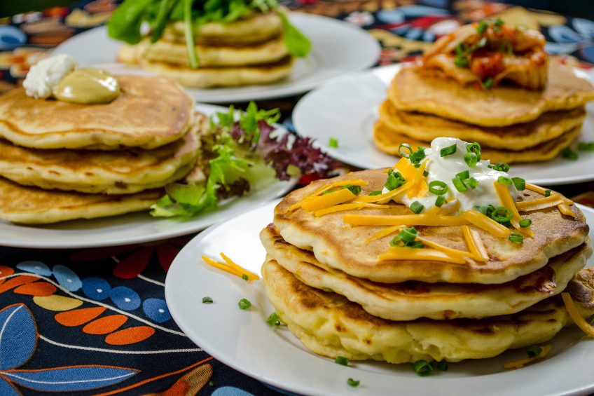 Four plates stacked high with savoury pancakes