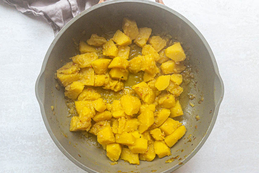 Squash sauteing in a pan