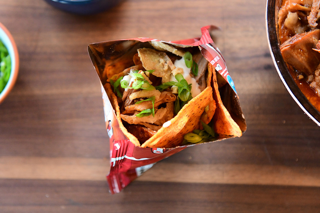 bag of taco chips filled with pulled pork