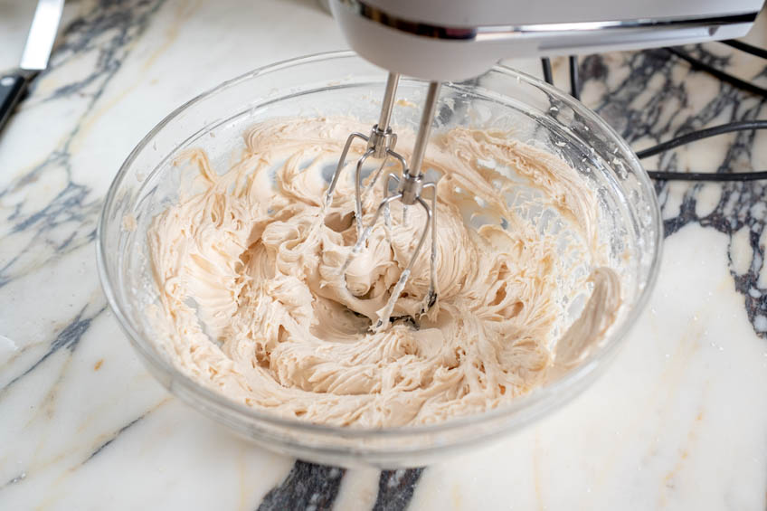 Salted Caramel Cream Cheese Frosting being whipped in a bowl