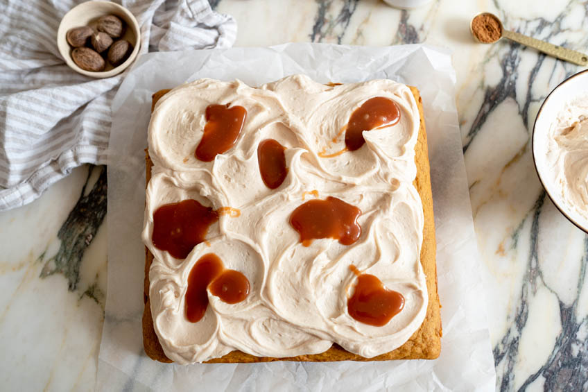 Pumpkin Snack Cake with Salted Caramel Cream Cheese Frosting dolloped with salted caramel