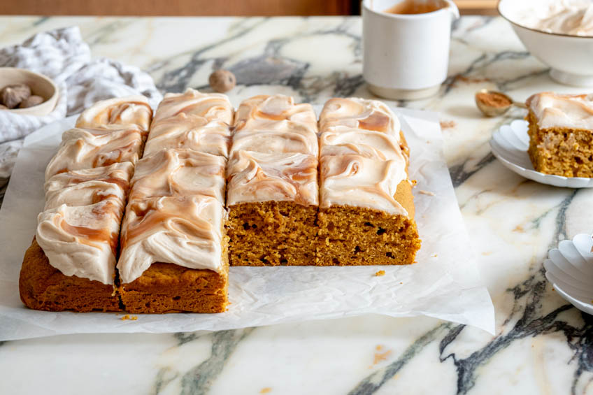 Pumpkin Snack Cake with Salted Caramel Cream Cheese Frosting cut into 12 squares