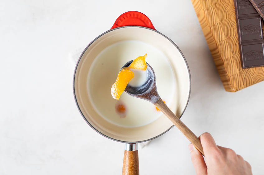 Orange zest in a simmering pot of milk