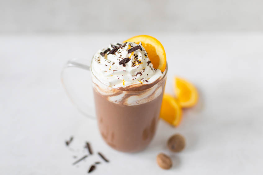 A glass mug of chocolate orange hot chocolate