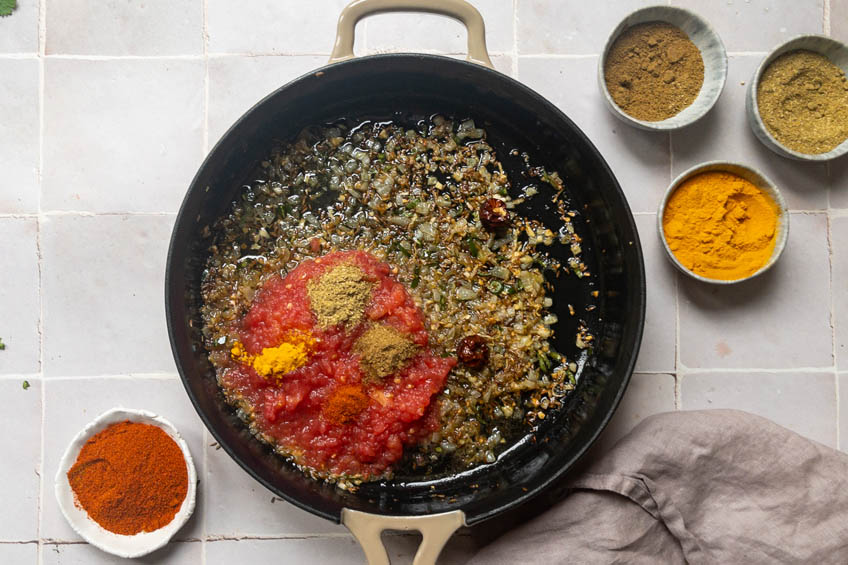 Tadka ingredients in a skillet