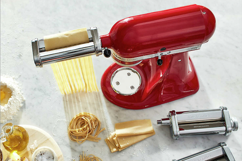 A shot of a red Kitchenaid stand mixer with fresh pasta maker attachment