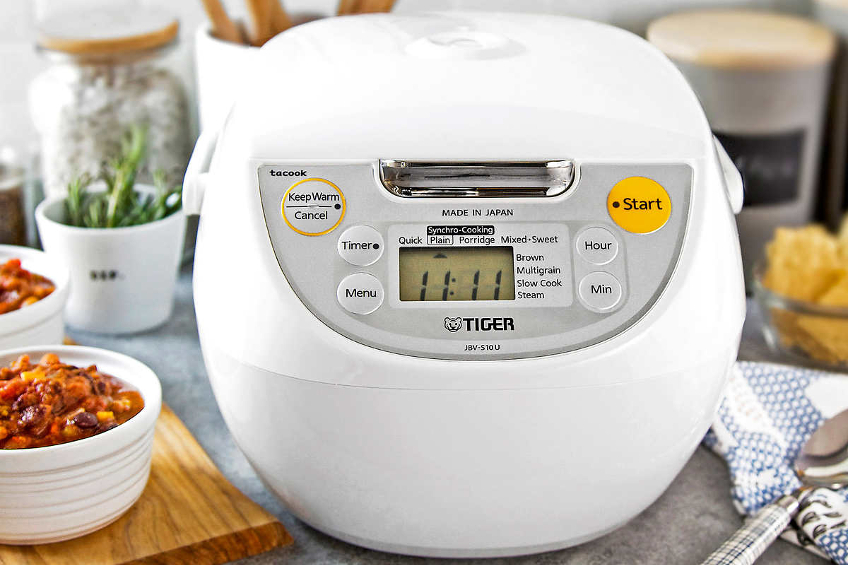 A shot of a white rice cooker on a counter