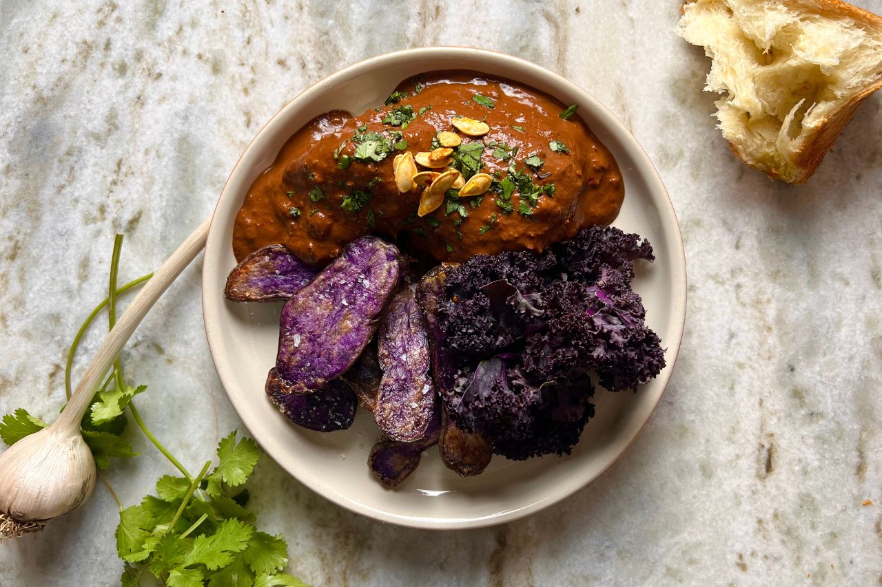 mole sauce with chicken, black kale and purple potatoes