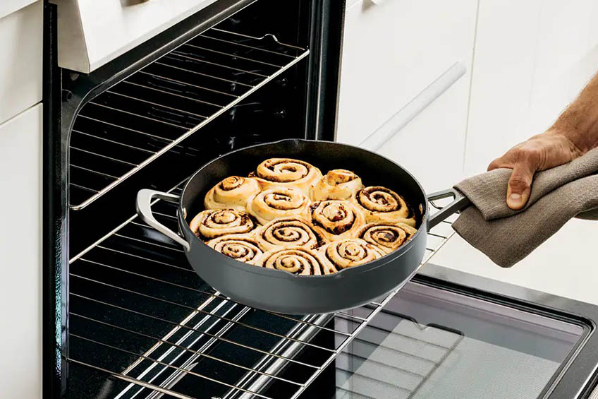 Ninja Foodi Possible Pan being taken out of the oven with cinnamon rolls inside