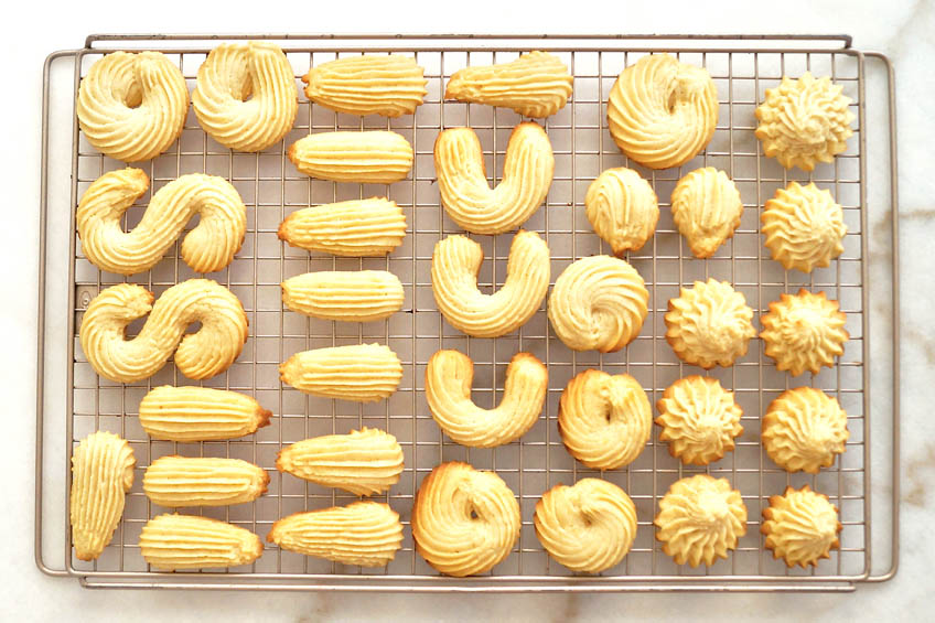 Spritz cookies on a cooling rack
