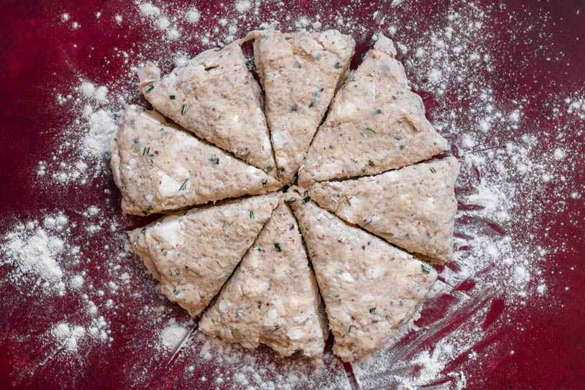 The dough for vanilla rosemary scones cut into eight triangular slices