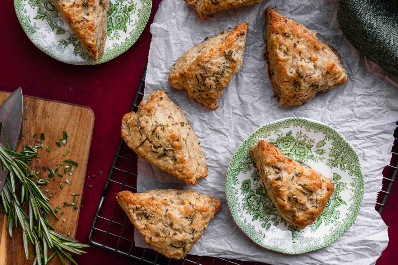 Vanilla rosemary scones on parchment paper and a plate