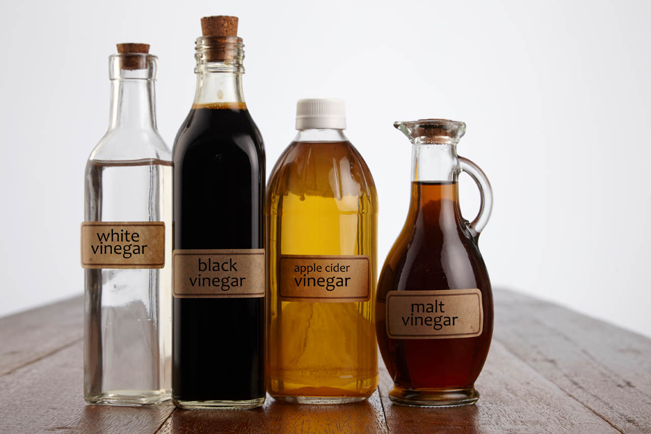 Four different bottles of diffrerent kinds of vinegar
