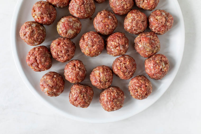 Uncooked meatballs on a plate