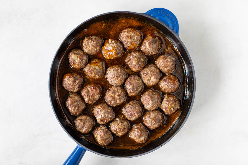 Meatballs in a skillet of sweet and sour sauce