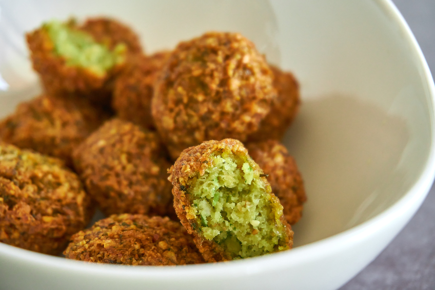A white bowl filled with cooked falafel