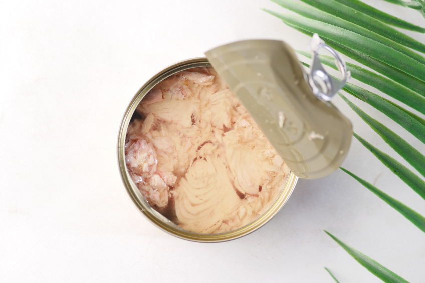 A can of tuna with the lid partially opened