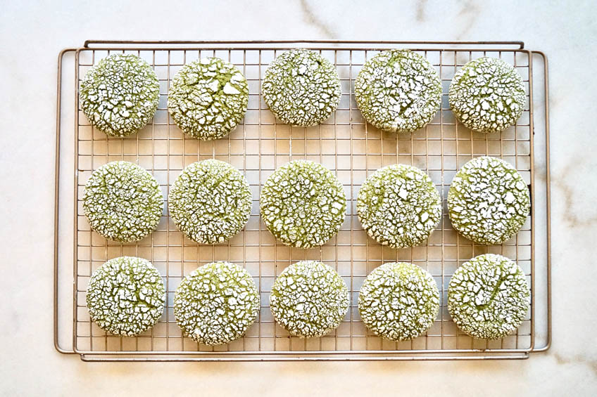 Matcha crinkle cookies on a cooling rack