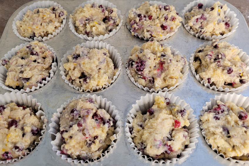 Unbaked arctic cranberry orange muffins in a muffin tin