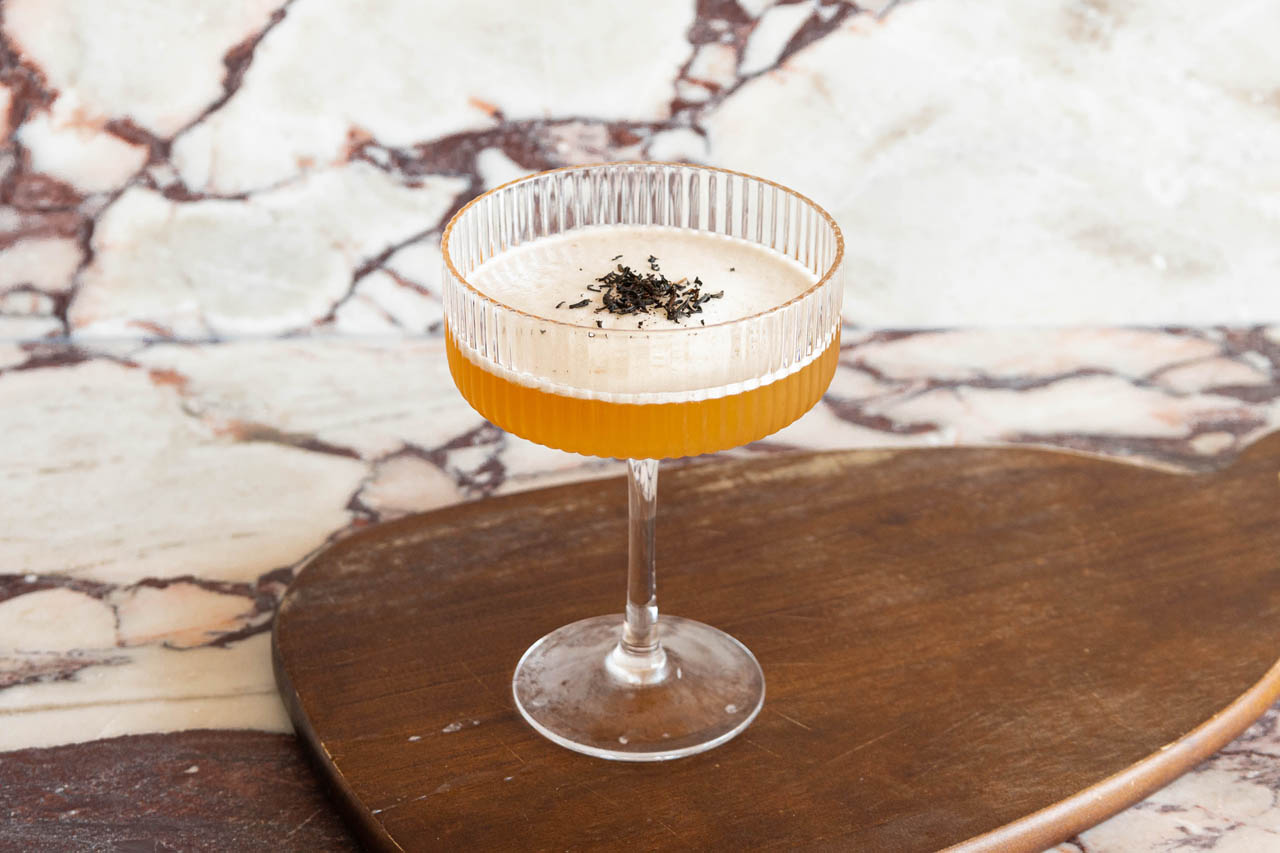 A non-alcoholic Earl Grey Sour in a cocktail coupe